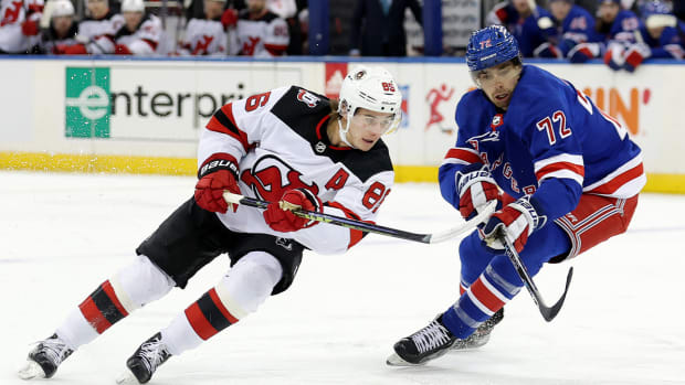 Dec 12, 2022; New York, New York, USA; New Jersey Devils center Jack Hughes (86) fights for the puck against New York Rangers center Filip Chytil (72) during the first period at Madison Square Garden.